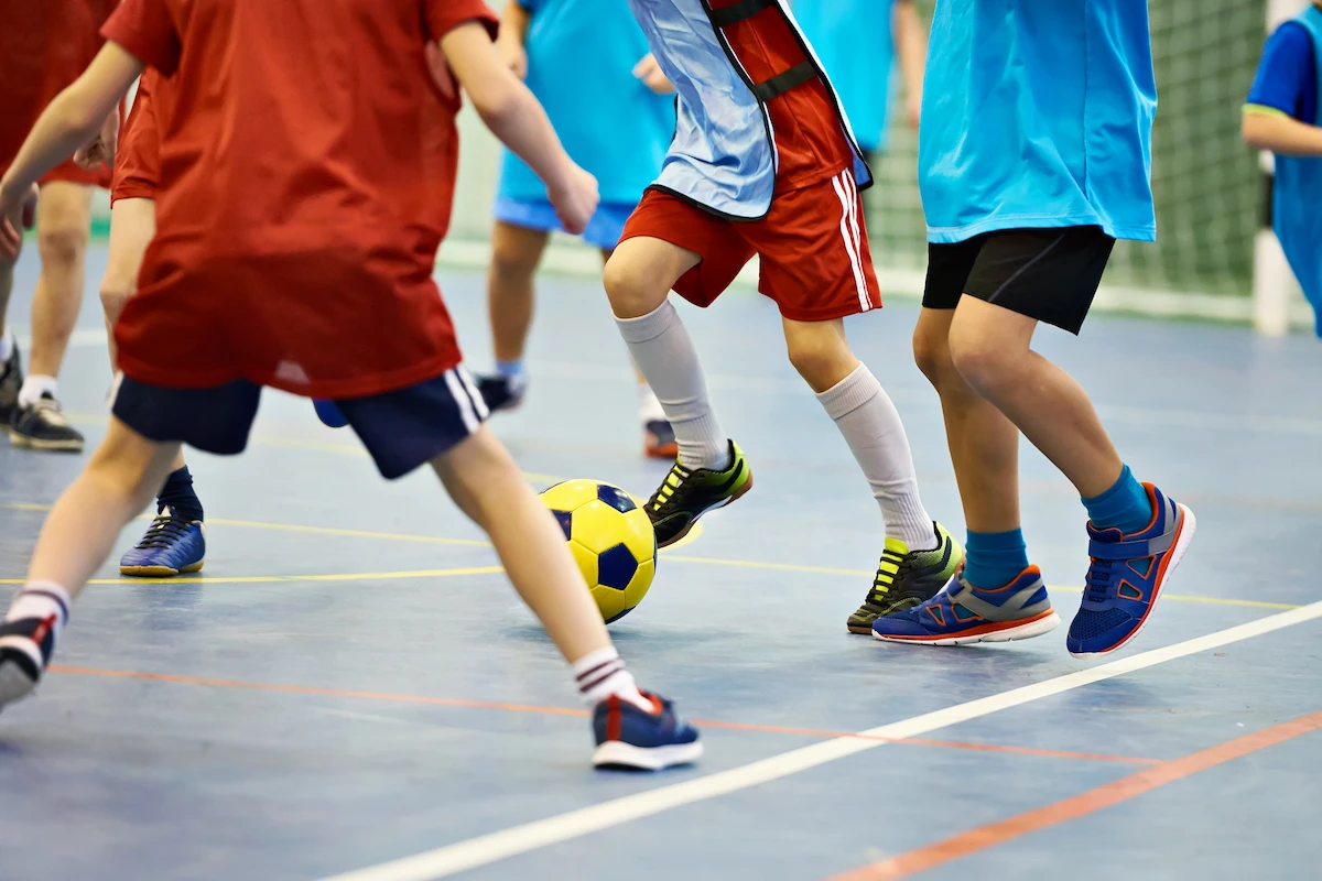 children-soccer Close-up of children playing soccer indoors
